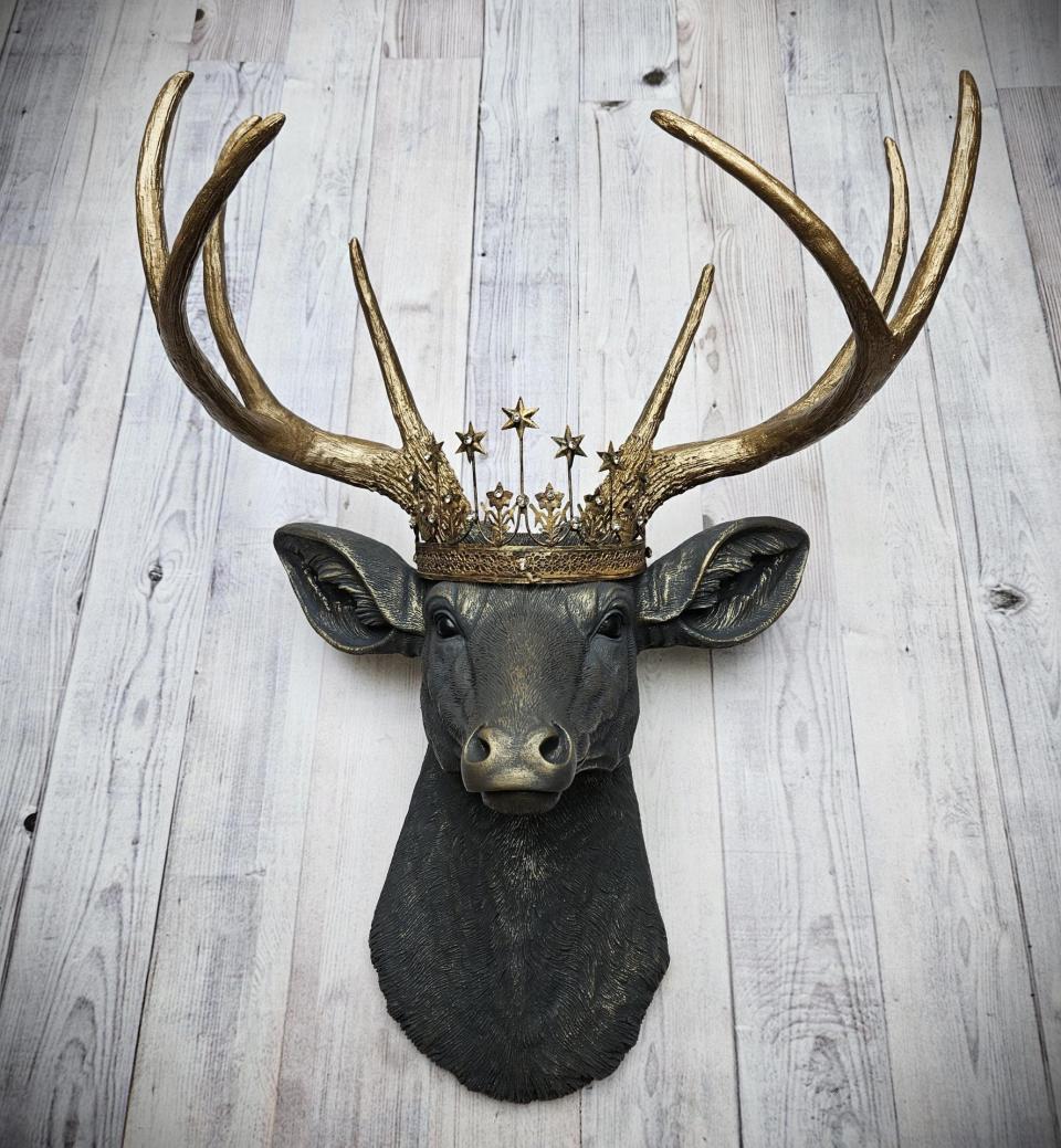Faux taxidermy deer head, painted slate grey with antique gold accents. The antlers are antique gold and a vintage inspired Santos star crown rests atop the deers head.